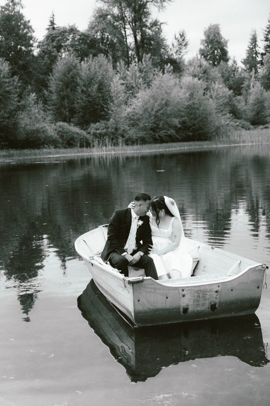 Black and white of a couple in a rowboat on a lake