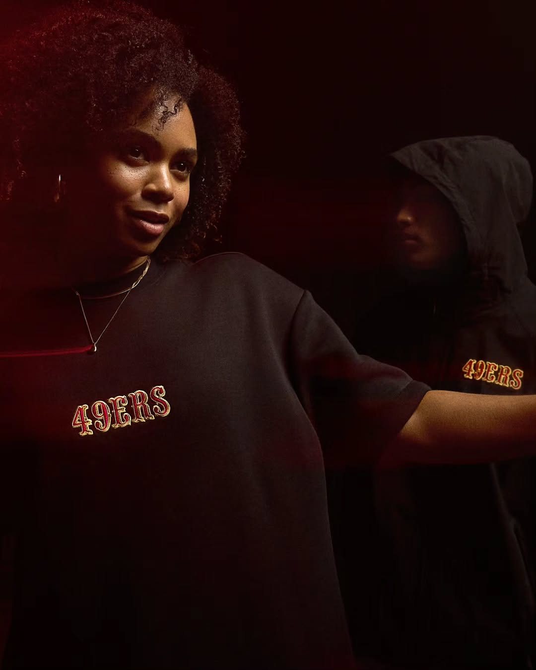 Woman in a 49ers tee with red light