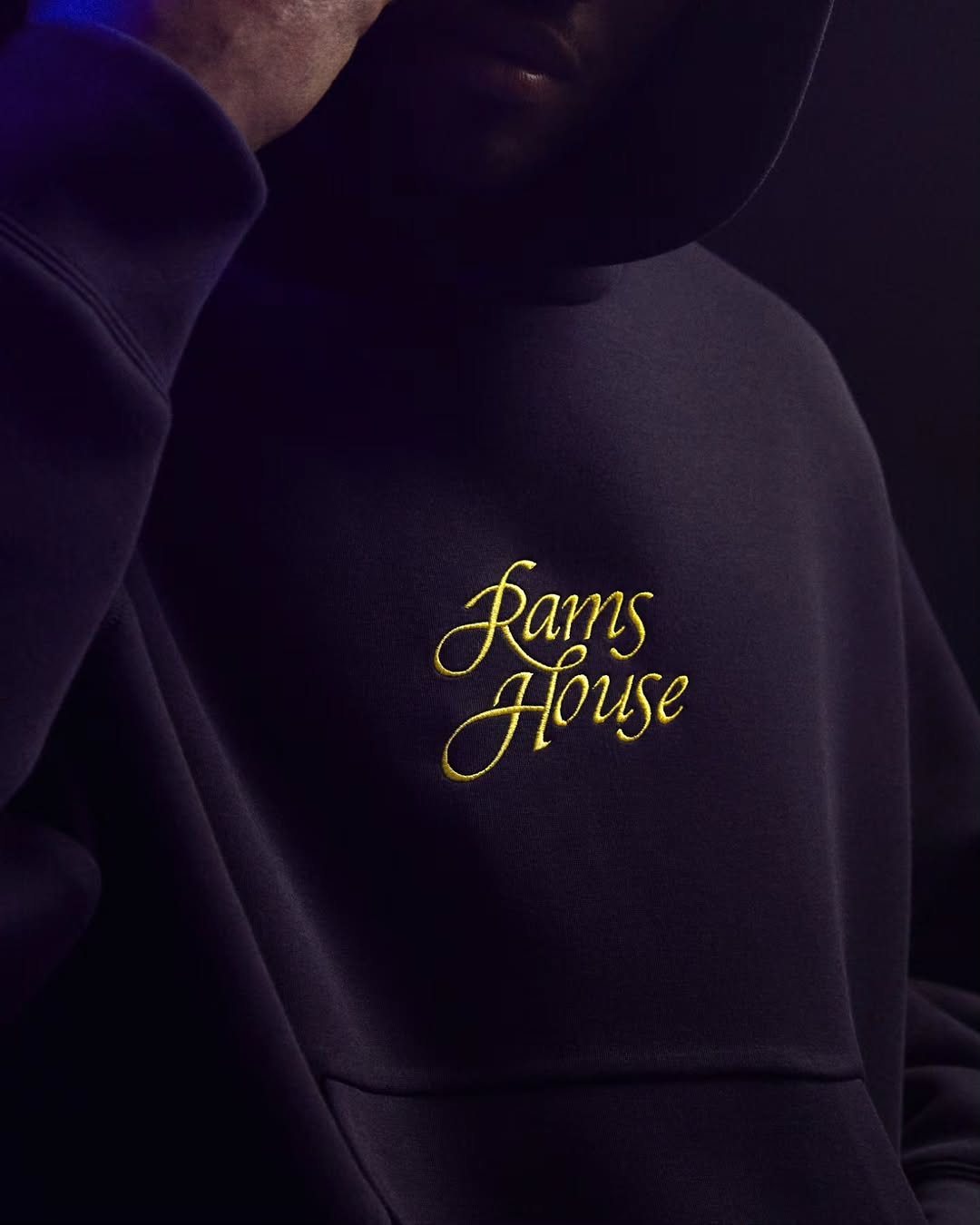 Close up of a Rams House hoodie in violet light