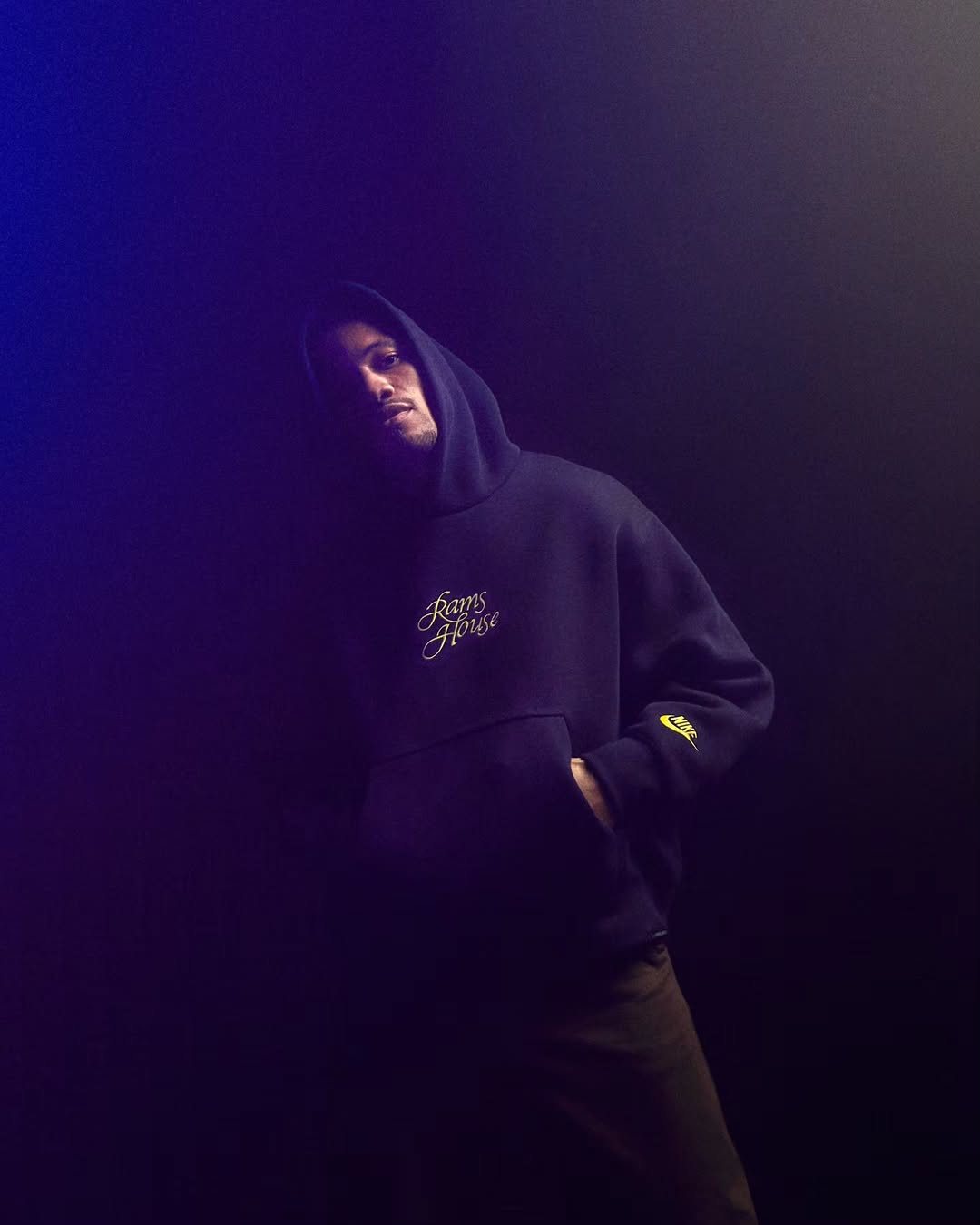 Man in a Rams House hoodie in blue light