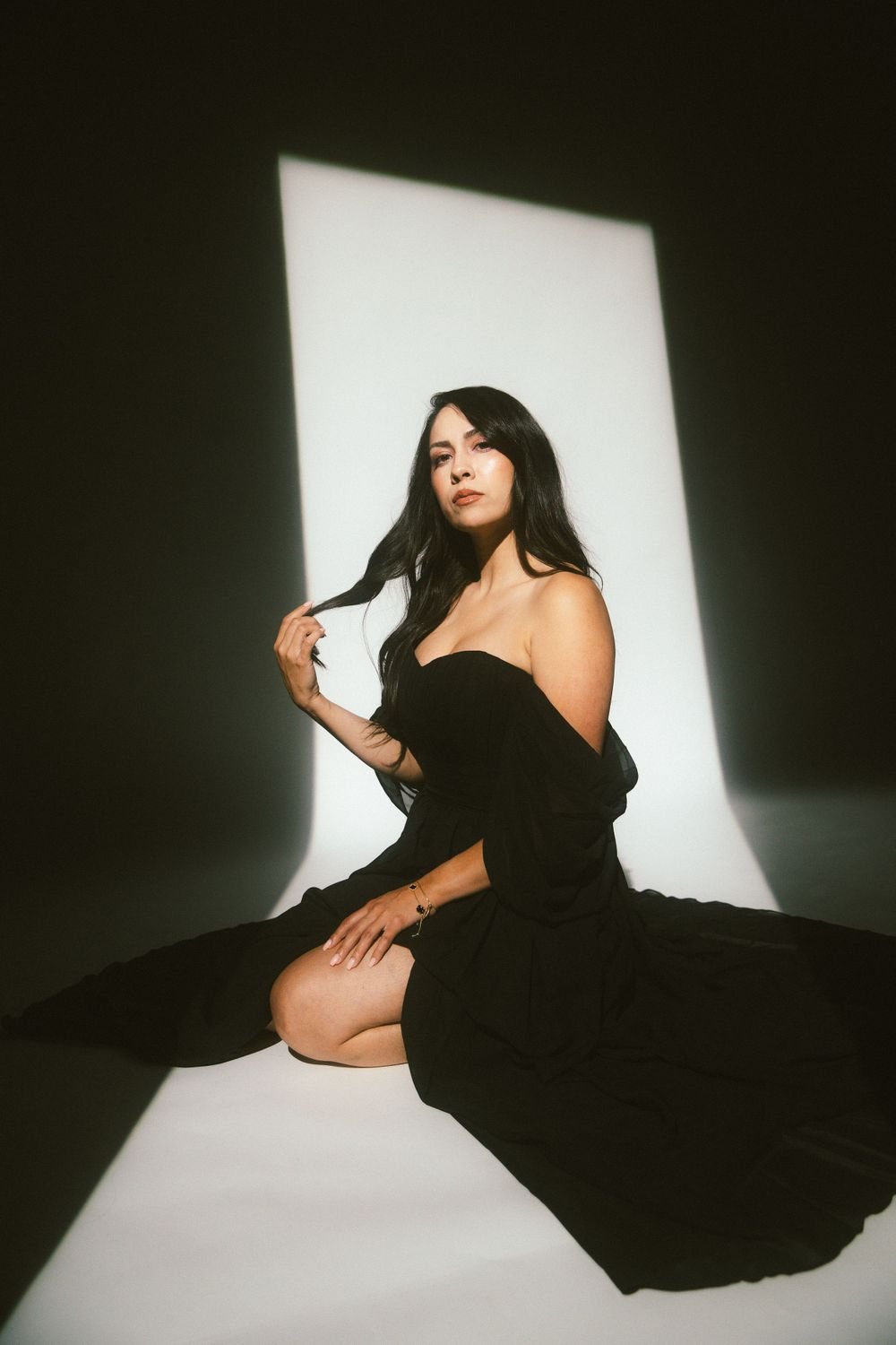 Woman in a black dress on a white sweep